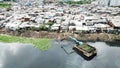 Slum houses and an excavator on lakeside