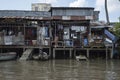 Slum houses on tilts on the Mekong River in Vietnam