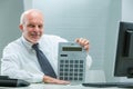 Sly businessman wields calculator, implying deceit