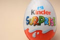 Slynchev Bryag, Bulgaria - May 25, 2023: Kinder Surprise Egg on beige background, closeup. Space for text