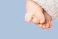Smal baby feet with blue terry towel on blue background Royalty Free Stock Photo