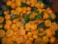 Smal bitter oranges Chinotto and mint leafs boiling in water in a steelpan Royalty Free Stock Photo