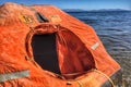 A smal life raft floating on the sea Royalty Free Stock Photo