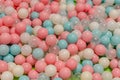 Smal plastic balls for indoor ball pit children kids playground. White blue pink colored background Royalty Free Stock Photo