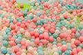 Smal plastic balls for indoor ball pit children kids playground. White blue pink colored background Royalty Free Stock Photo