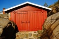 Smal red boat house at the harbor, Norway