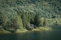 Smal red cottage inside the forest close to the lake Royalty Free Stock Photo