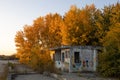 Small abandoned concrete building at autumn