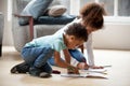 Small black siblings drawing together with colorful pencils Royalty Free Stock Photo