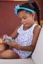 Small african american girl using a mobile phone Royalty Free Stock Photo