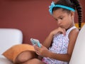 Small african american girl using a mobile phone Royalty Free Stock Photo