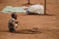 Small african boy squatting Royalty Free Stock Photo