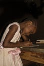 Small African girl doing homework