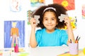 Small African girl holds puzzle pieces together Royalty Free Stock Photo