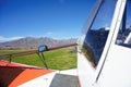 Small aircraft on rural airstrip, ready for take-off.