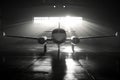 Private Jet in Hangar: Dramatic Black and White Image Royalty Free Stock Photo