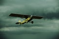 Small airplane against stormy sky