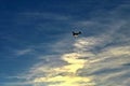 Small airplane on blue sky with clouds and sunset in background Royalty Free Stock Photo