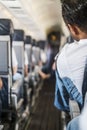 Small airplane corridor with passengers. Royalty Free Stock Photo