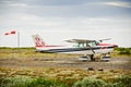 Small airplane on a dirt airstrip in Iceland with a sheep in front. Cessna 172. Hofn, Iceland - 03/06/2019