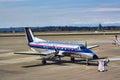 Small airplane, Embraer EMB 120 Brasilia, parked on a Seattle-Tacoma International Airport runway