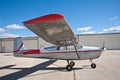 Small airplane in front of hangars Royalty Free Stock Photo