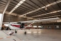 Small airplane with propeller in front parking in terminal. Royalty Free Stock Photo