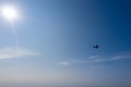 Small airplane silhouette in flight against the backdrop of the clear blue sky. aerial view Royalty Free Stock Photo