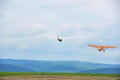 Small airplane helping a sailplane into sky Royalty Free Stock Photo