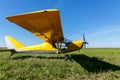 small airplane waiting on field, Yellow plane on the grass.