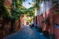 Small alley in the famous quarter trastevere in rom, italy. typical houses with colorful facades in a gasse with antique cobblesto