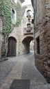 A small alley surrounded by stone walls in a village in spain