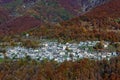 Small alpine village among colorful trees in Switzerland.