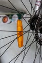 Small amber bicycle reflector mounted on the wheel spokes close up shot Royalty Free Stock Photo