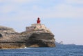 Small ancient red lighthouse near Bonifacio Town in Corsica in E Royalty Free Stock Photo