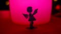 small angel girl figure silhouette near bright colorful lamp Royalty Free Stock Photo