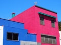 Small angular pink and blue modern concrete houses in Spain