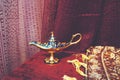 Small Antique Aladdin Lamp. Macro. Antique object on the background of carpets. Royalty Free Stock Photo