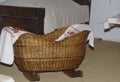 A small antique wooden cradle on wooden legs for a small baby. Royalty Free Stock Photo