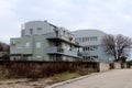 Small apartment building with curved metal roof