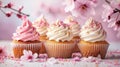 small apity magnificent cupcake and some sprinkles with pink blossoms, soft light background, banner Royalty Free Stock Photo