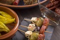 Small appetizers on skewers with dried tomatoes