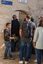 The small Arab sells olive branches near the entrance to the courtyard of Chapel of the Ascension on Mount Eleon - Mount of Olives