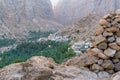 Small arabian mountain village of Mibam in the gorge of Wadi Tiwi, Oman. Steep sandstone cliffs, green palm trees in the