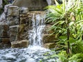 A small artificial waterfall feature in a modern luxury home setting