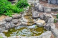 Small artificial waterfall made of granite stones. A waterfalls made of artificial rock in the state park. Cold mountain Royalty Free Stock Photo