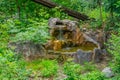 Small artificial waterfall made of granite stones. A waterfalls made of artificial rock in the state park. Cold mountain Royalty Free Stock Photo