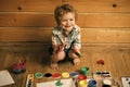 Small artist. Boy painter painting on wooden floor Royalty Free Stock Photo