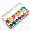 Small artist\'s paint palette with colorful paints isolated on white background