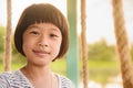 A small Asian girl is smiling happily.